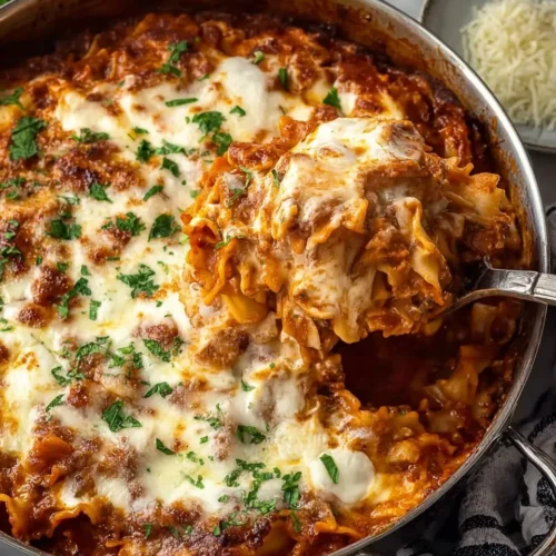 Alt Text: One-Pan Skillet Lasagna Recipe with melted mozzarella, ricotta dollops, and ground beef and pasta sauce, garnished with fresh parsley.