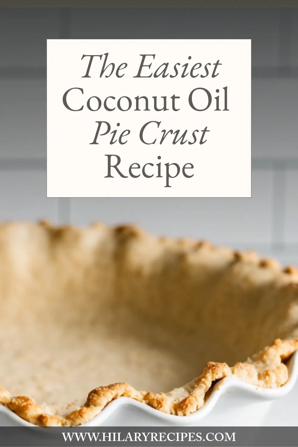 Coconut Oil Pie Crust pin A close-up shot of a golden-brown, flaky, baked pie crust in a white fluted dish. A text overlay reads: "The Easiest Coconut Oil Pie Crust Recipe"