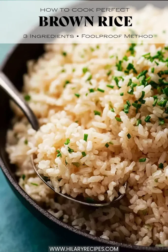 overhead shot of a dark bowl filled with perfectly fluffy brown rice garnished with fresh chopped chives, with a spoon scooping up a serving. Text overlays read "How to Cook Perfect Brown Rice," "3 Ingredients • Foolproof Method,"